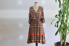 Vintage floral prairie maxi crochet dress with earthy browns, beige, and orange floral pattern throughout.  Elbow length sleeves with stunning Neckline and drawstring waist. Beautiful earthy rust crochet throughout sleeves and along mid dress. Perfect with flats or boots and layers. In excellent vintage condition. Material- Rayon Size L  Measurements- Length- 125cms l ' inches Bust- 53cms l ' inches Sleeves- 41cms l ' inches Hippie Brown Floral Print Dress, Bohemian Brown Floral Print Midi Dress, Orange Bohemian Knee-length Midi Dress, Woodstock Hippies, Beau Crochet, Mid Dress, Full Length Dress, Mid Dresses, Elbow Length Sleeve