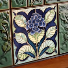 decorative tiles with blue flowers and leaves on them