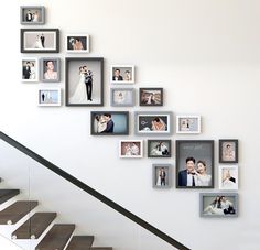 a staircase with many pictures on the wall