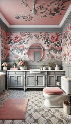 a bathroom with floral wallpaper and pink accents