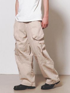 This is a comfortable cargo pants that is made out of sturdy cotton 100% fabric. With a unique cut pattern and wide adjustable silhouette with snaps on the hem, you can wear it for casual and daily outfit. - YKK zipper closure- Adjustable YKK snaps on the hem- Leather logo label detail- Wide silhouette Khaki Techwear Bottoms With Cargo Style, Khaki Wide Leg Techwear Cargo Pants, Cotton Cargo Jeans In Straight Fit, Baggy Khaki Cargo Pants With Cargo Pockets, Baggy Khaki Bottoms With Flap Pockets, Urban Khaki Straight Cargo Pants, Urban Straight Khaki Cargo Pants, Khaki Cotton Parachute Pants With Multiple Pockets, Relaxed Fit Khaki Cargo Pants With Multiple Pockets