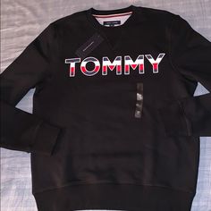 Tommy Hilfiger Pull-Over New With Tag Tommy Hilfiger Sporty Black Tops, Tommy Hilfiger Black Tops For Fall, Tommy Hilfiger Black Long Sleeve Top, Black Tommy Hilfiger Tops For Fall, Tommy Hilfiger Black Crew Neck Top, Tommy Hilfiger Crewneck, Tommy Hilfiger Hoodie, Tommy Hilfiger Sweatshirt, Tommy Hilfiger Logo