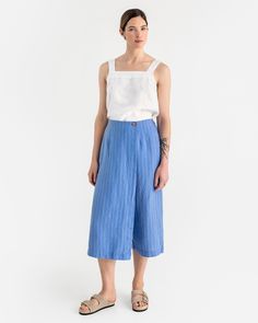 These unique linen culotte pants BUSAN in blue stripes blend style and comfort seamlessly. They come with an elastic back waist for comfort, front seams for a tailored look, and a discreet zipper closure for ease of wear. The skirt element is enhanced with a coconut button, adding a fashionable detail, while side pockets provide convenient utility. Details: * Loose fit * 3/4 length * Elasticated waist at the back  * Pants feature a secret zipper closure * Skirt part finished with a coconut butto Linen Palazzo Pants, Linen Culottes, Wrinkled Clothes, Oversized Pants, Linen Bottoms, Culotte Pants, Womens Trousers, Linen Skirt, Clothing Care