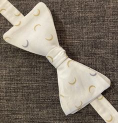 You'll love this Crescent Moons Bow Tie for a mysterious look! Comes in multiple colours. -Pre-tied but can be re-tied -Back clasp -Adjustable -13.5 cm wide X 6 cm high -39.5 cm to 52.5 cm long White Adjustable Standard Tie, White Adjustable Bow With Butterfly Knot, Adjustable White Bow For Black Tie Occasion, White Adjustable Bow Tie For Black Tie Occasions, Adjustable Pre-tied Bow Tie, Adjustable White Bow Tie, Adjustable White Bow Tie With Butterfly Knot, White Adjustable Standard Bow Tie, White Summer Bow For Gifts