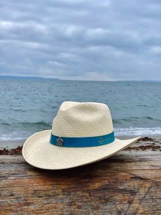 Ocean Western is a Southern-inspired Panama hat made for the long haul. It features a 3 ½” stiffened brim with raised edges and a wire to hold its shape. Handwoven from 100% Toquilla straw and finished with a handcrafted leather hatband, teardrop pinched crown and a sea turtle pin for details. The Ocean Western Panama hat was created with the purpose of donating 5% of each Ocean Western sold to the Sea Turtle Conservancy, the world’s oldest sea turtle research and conservation group that carries Country Style Toquilla Straw Hat For Travel, Straw Hat Bands With Short Brim For Rodeo, Western Style Palm Leaf Straw Hat With Flat Brim, Western Palm Leaf Hat With Curved Brim, Curved Brim Woven Sun Hat For Rodeo, Woven Sun Hat With Curved Brim For Rodeo, Woven Toquilla Straw Hat Bands For Rodeo, Straw Panama Hat With Curved Brim, Adjustable Wide Brim Toquilla Straw Hat