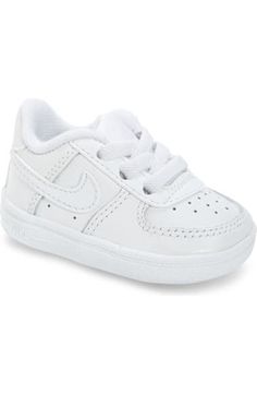 a white nike sneaker with two straps on the side and one shoe laces down