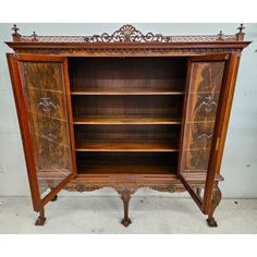 an antique wooden bookcase with ornate carvings