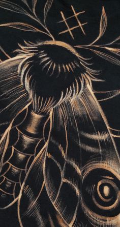 a drawing of a horse's head in gold and black ink on a black background