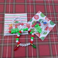 two christmas themed items on a red and green plaid tablecloth, one with beaded bracelets