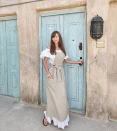 a woman standing in front of a blue door