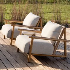 two chairs sitting on top of a wooden deck