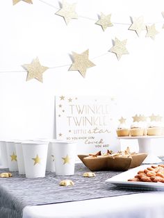 a table topped with cupcakes and other desserts next to a sign that says twinkle twinkle