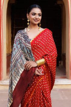 Red pure bandhani gajji silk saree with floral ajrakh hand block printed pallu and a yellow bandhani border around all edges. Comes with unstitched beige blouse piece with ajrakh hand block print. - Aza Fashions Red Choli With Kalamkari Print For Navratri, Red Kalamkari Art Silk Blouse Piece, Traditional Red Bandhani Blouse Piece, Red Kalamkari Choli For Navratri, Red Blouse Piece With Bandhani Print For Navratri, Red Bandhani Print Blouse Piece For Navratri, Red Bandhani Print Chanderi Choli, Red Cotton Silk Choli With Traditional Drape, Traditional Pre-draped Saree With Bandhani Print For Festivals