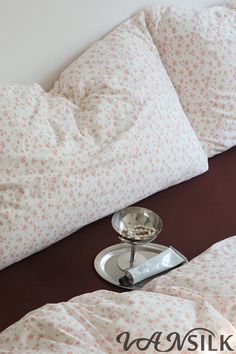 a bed with two pillows and a tray on it