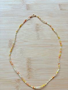 pumpkin spice themed seed bead necklace! Seed Need Necklace, Autumn Seed Bead Necklace, Yellow Necklaces With Round Letter Beads, Yellow Necklaces With Letter And Round Beads, Yellow Necklace With Letter Beads, Autumn Beaded Necklace, Bohemian Yellow Necklace With Letter Beads, Orange Necklace With Letter Beads For Gifts, Adjustable Orange Beaded Necklace With Letter Beads