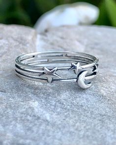 Moon and Stars Silver Ring | The Life Divine Moon and Stars Layered Cut Out Sterling Silver RingThe Moon is a feminine symbol and represents the light that shines within each of us. She reminds us that all things on earth have a natural cycle.The stars which light up the evening sky inspire us to dream. Sterling SilverRing measures 1/4". Adjustable Celestial Star-shaped Rings, Adjustable Star-shaped Magical Jewelry, Nickel-free Celestial Moon Ring, Adjustable Moon Shaped Celestial Rings, Adjustable Moon-shaped Celestial Rings, Celestial Star-shaped Midi Rings As Gift, Adjustable Moon Shaped Celestial Midi Rings, Adjustable Moon-shaped Celestial Midi Rings, Adjustable Celestial Moon Midi Rings