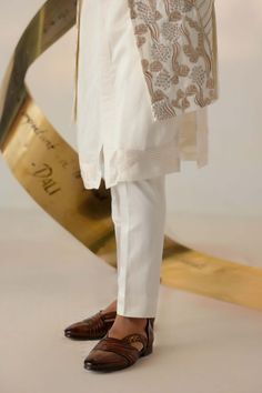 Editor's Note Featuring the new dali dirty ivory shrug set curated using four different types of embroidery. This ivory and gold-based ensemble is perfect for your day's wedding festivities. Paired with a matching front open kurta and tapered trousers. Fabric: Linen silk Color: Ivory Components: Shrug, kurta, trousers Occasion: Wedding guest Fit: Regular Note: Product colour may slightly vary due to photographic lighting sources Care: Dry clean only About the Designer After establishing himself Different Types Of Embroidery, Blouse Yoke, Wedding Festivities, Dhoti Pants, Types Of Embroidery, Tapered Trousers, Indian Wedding Outfits, Embroidered Neckline, Band Collar