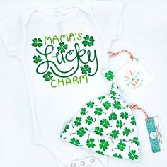 Do you feel like you won the baby lottery? Well then you'll love our "Lucky Charm" baby onesie, which is made in the USA from 100% organic cotton! Featuring a lapped neckline and 3 metal snaps for easy on/off diaper changes, this design makes an especially adorable baby shower gift for parents or Irish descent, babies born in March, or those who love celebrating St. Patrick's Day! Available in sizes 0-3M, 3-6M, 6-12M, and 12-18M. Shades of green and White. Vinyl heat transfer print. Each baby on Playful Cotton Bodysuit As A Gift, Cotton Onesie Gift For Spring, Newborn Baby Gift Set, Born In March, Irish Baby, Clover Design, Newborn Baby Hats, Feeling Lucky, Newborn Hat