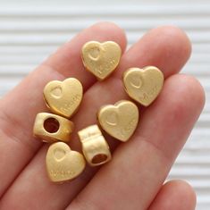 Mom charm gold, mom heart charm, bead sliders, mom heart pendant, family charms, heart beads, mother's day gift, gifts for mom 12 mm x 11 mm Hole: 4 mm Please choose the quantity you want!  Would you like to see more heart findings? Just click the link below:  https://www.etsy.com/shop/EastVillageSupply?ref=hdr_shop_menu&search_query=heart Flower findings? Just click the link below:  https://www.etsy.com/shop/EastVillageSupply?ref=hdr_shop_menu&search_query=flower More charms and beads?  https://www.etsy.com/shop/EastVillageSupply?ref=seller-platform-mcnav&section_id=18473488 -Actual colors of any item or natural stones may slightly differ from screen to screen due to the screen resolution.  -I take all photos in daylight. But, due to the nature of gemstones, you might notice slightly diff Cheap Heart-shaped Charm Necklace For Mom, Mother's Day Jewelry Gift, Heart Charm, Heart-shaped Gold Charm Necklace For Mom, Gold-plated Heart Charm Jewelry For Mother's Day, Heart-shaped Flower Charm Jewelry For Mother's Day, Family Charms, Heart Flower, Flower Heart, Heart Beads