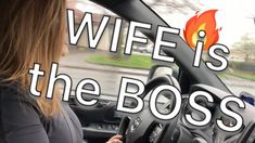 a woman driving a car with the words wife is the boss in front of her