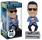 a figurine of a man wearing sunglasses and a blue suit is in front of a box