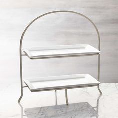 a three tiered metal rack with two shelves