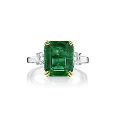 This 3 stone, 4.99ct natural green emerald ring. Flanked by Cadillac-cut diamonds weighing 0.49 carats. Has 18KT yellow gold prongs and diamonds are set in 18kt white gold and a polished 18kt white gold band. The ring total weight is 5.48 carats. Green Three-stone Emerald-cut Emerald Ring, Three-stone Emerald Cut Green Emerald Ring, Green Three Stone Emerald Cut Emerald Ring, Green Emerald Cut Three Stone Emerald Ring, Asscher Cut Emerald Ring With Diamond Accents, Luxury Three Stone Diamond Emerald Ring, Three-stone Diamond Emerald-cut Ring, Luxury Three Stone Emerald Ring, Luxury Three Stone Asscher Cut Emerald Ring