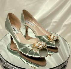 "Sage Green Wedding Shoes with sparkling crystal and pearl design.  The listing picture shoes a comfortable 2 inch shoe (also available in 3 inch heels) have been hand dyed Sage, but is also available in over 100 different colors as well as the option of sending us a sample to color match for you!   If you would like a chart color or or David's Bridal color or the 3 inch heel size, please leave us a note in the personalization box. DYE COLORS: My goal is for you to have your shoes dyed the exact color you want.  Please understand that all computer monitors/phone screens are set to different settings which could make the color of the shoes you see in the listing picture appear slightly different than they are in person.  To help with this, I would be happy to send you a swatch of the color Heels For Green Prom Dress, Sage Green Quinceanera Heels, Sage Green Heels Prom, Elegant Pearl Embellished Heels For Reception, Elegant Pearl Embellished Wedding Shoes For Reception, Sage Green Wedding Shoes, Green And Gold Heels, Sage Heels, Sage Green Shoes