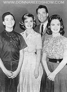 an old black and white photo of four people