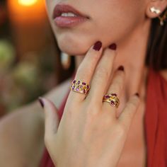 Trio Ruby Gemstone & Gold Stylish Adjustable Cocktail Ring, a luxurious and versatile piece designed to bring elegance to both casual and formal settings. This stunning ring features three beautifully arranged oval ruby gemstones, set against a 24k gold-plated base. The vibrant red rubies add a touch of sophistication and charm, making it the perfect accessory for any occasion. With its adjustable band, the ring offers a comfortable and stylish fit, effortlessly transitioning from day to night D Elegant Multi-stone Ruby Ring, Luxury Rings With Stones, Elegant Multi-stone Ruby Open Ring, Elegant Open Ring Jewelry With Stones, Elegant Multi-stone Open Ruby Ring, Elegant Red Rings With Stones, Elegant Ruby Ring With Gemstone Accents For Anniversary, Luxury Formal Rings With Stones, Elegant Ruby Ring With Diamond Accents