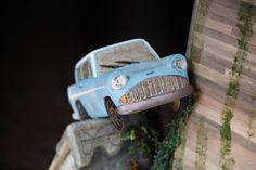 a toy car is sitting on top of a ledge