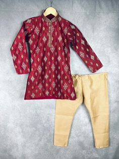 Boys Kurta Pajama Set in Raw Silk material with Cotton Lining. Kurta has Ikkat designs on the back, front and sleeves. The neckline has beautiful lace work and fancy buttons. Item : Boys Kurta Pajama Ready to Wear : Yes Kurta Color : Maroon Kurta Fabric : Raw Silk Pajama Color : Gold Fabric : Raw Silk Pocket : Yes Lining (Yes/No) : Yes (Cotton Lining in Kurta) Disclaimer - There can be little variation in the color due to screen resolution setting, phone display setting or anything else. Kindly Kurta Pajama For Boys, Kids Indian Wear, Phone Display, Boys Kurta, Fancy Buttons, Silk Pajama, Kurta Pajama, Gold Fabric, Boys Pajamas