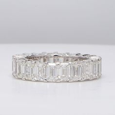 Ninacci 14K White Gold Eternity Band with Shared Prong Set Emerald-Cut Diamonds - 7.15 Carat Total Diamond Weight - Size 7 Luxury Modern Eternity Band With Prong Setting, Fine Jewelry Emerald Cut Baguette Diamond Eternity Band, Emerald Cut Cubic Zirconia Eternity Band With Baguette Diamonds, Timeless Emerald-cut Cubic Zirconia Eternity Band, Emerald Cut Diamond Eternity Band With Baguette Diamonds, Emerald Cut Baguette Diamond Eternity Band, Timeless Emerald Cut Diamond Eternity Band, Fine Jewelry Diamond White Emerald Cut Eternity Band, Emerald Cut Moissanite Eternity Band In Fine Jewelry Style