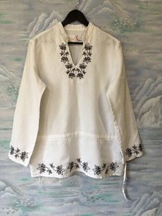 "Women's White Linen Blouse Long White Shirt Embroidered White Shirt Extra Large Size Blouse Shirt Dress Estimated size: F 44/ UK 16/ D 42/ NL 42/ Material: 100%Linen Measurements: (lying flat) Length - 28,3\" / 72 cm Shoulders: 16.5\" / 42 cm Bust: 21.6\" / 55 cm Waist - 21.6\" / 55 cm Sleeve: 23,6\" / 60 cm Please check measurements to insure a proper fit. Remember to allow yourself some extra room for movement. You can compare these with something from your closet that fits you well. This blo White Embroidered V-neck Kurta, White Cotton Tunic Shirt, White Long Sleeve Tunic With Chikankari Embroidery, White Long Sleeve Chikankari Tunic, Traditional V-neck Blouse With Embroidered Hem, White Summer Shirt With Chikankari Embroidery, White Long Sleeve Embroidered Top, Beach Embroidered Collared Shirt, White Embroidered Beach Shirt