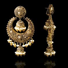 A fun pair with classic deign that never goes out-of-style! Gorgeous pair of earrings that is a perfect pick to pull-off any traditional or ethnic look. With its beautiful metal carving, embossed details and timeless jhumki design with an addition to pearl moti, this pair is all you need for the upcoming events. Kajal Earrings are available in two sizes. Big earrings are about 4.5" long and small earrings are about 3" long. Gold-plated on high-quality brass as base metal. Delivery time frame is Traditional Earrings With Intricate Design, Ornate Chandbali Brass Jewelry, Elegant Oxidized Earrings For Ceremonial Occasion, Bollywood Filigree Earrings For Wedding, Elegant Ceremonial Earrings With Oxidized Finish, Ceremonial Chandbali Metal Earrings, Ornate Metal Chandbali Jewelry, Ornate Jhumkas For Pierced Ears, Gold Bollywood Earrings With Intricate Design