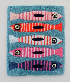 a rug with fish on it hanging on the wall