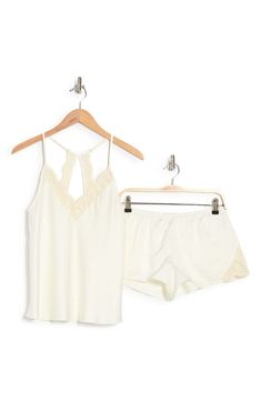 Perfect for romantic evenings, this elegant pajama set crafted in smooth matte satin includes a lace-trimmed racerback camisole and matching shorts. 2-piece set Top has V-neck; adjustable straps; open racerback; scalloped lace trim; satin construction Shorts have elastic waist; scalloped lace trim; satin construction 100% polyester Hand wash, dry flat Imported Model stats: 5'10" height, 32" bust, 25" waist, 36" hip. Model is wearing size S. Feminine Cami Sleepwear For Night, Feminine Camisole Sleepwear For Loungewear, Cream Camisole Sleepwear For Spring, Feminine Sleeveless Loungewear Sets, Cream Summer Sleepwear For Night, Cream Sleepwear For Wedding Night In Summer, Elegant Night Sets For Summer, Elegant Summer Night Sets, Feminine Cream Sleepwear For Night