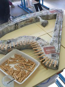 there is a tray of crackers and a container of water on the table next to it