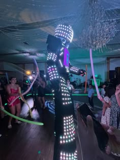 a woman in costume dancing with lights on her body