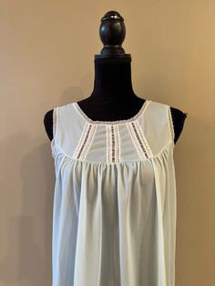 A lightweight sleeveless nightgown in light blue.  Lace trim on the bodice as well as the neckline and armholes.  The fabric is on the sheer side.  In good vintage condition with no rips or stains.  The bust measures 17.5 inches from armpit to armpit laying flat.  34 inches from shoulder to hem.  Tag reads Heiress size Medium. Summer Sleeveless Nightgown With Lace Trim, Casual Sleeveless Lace Trim Nightgown, Casual Sleeveless Nightgown With Lace Trim, Sleeveless Summer Nightgown With Lace Trim, Sleeveless Lace Trim Nightgown For Summer, Sleeveless Lace Trim Sleepwear For Summer, Sleeveless Nightgown For Summer Loungewear, Summer Camisole Nightgown With Lace Trim, Sleeveless Lace Trim Nightgown For Vacation