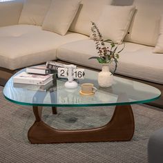 a glass coffee table sitting in front of a couch