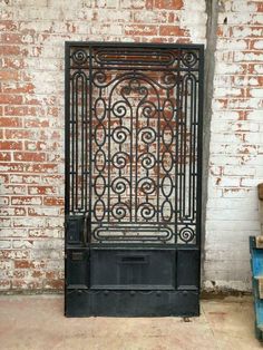 an old iron door is shown in front of a brick wall