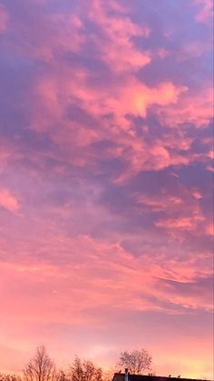 the sky is pink and purple with some clouds