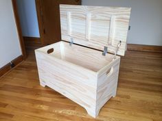 a large wooden box sitting on top of a hard wood floor