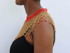 AMAZI Beaded cape necklace made using 100% fine beads.

Color: Red and Gold

Closure: hook

Length: 16 inches long

Material: Beads

It is made on order hence it's ready to ship within 1-3 days.

Shipping cost is calculated during checkout.

DHL Express shipping that takes  3-5 days to be delivered Elegant Festival Beaded Necklaces With Gold Beads, Elegant Gold Beaded Festival Necklaces, Elegant Bib Necklace With Round Beads For Festivals, Elegant Beaded Choker Necklaces For Festival, Elegant Bead Cap Necklaces For Festivals, Elegant Necklace With Bead Caps For Festivals, Elegant Large Bead Choker For Festivals, Elegant Festival Necklace With Bead Caps, Elegant Festival Choker With Large Beads