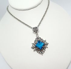 "This is a new handmade pendant. It is made with antiqued silver plated filigrees, featuring a high quality AQUA glass rhinestone/jewel that sparkles like crystal. Pendant measures 2 1/4\" tall (including the decorative bail) and 1 3/8\" wide and is worn on a sturdy rolo chain in your choice of length. This is also available in a variety of stone colors in our store, along with matching earrings." Gothic Blue Jewelry For Gifts, Elegant Pewter Necklace As A Gift, Blue Gothic Jewelry For Gifts, Elegant Pewter Necklace As Gift, Blue Gothic Jewelry For Gift, Elegant Pewter Necklace For Gift, Gothic Filigree Pendant Jewelry, Gothic Nickel-free Wedding Jewelry, Gothic Nickel-free Jewelry For Weddings