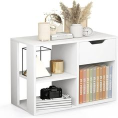 a white book shelf with books and other items