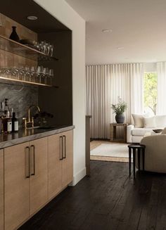 a living room filled with furniture next to a window