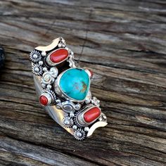 Turquoise and red corals set on traditional Tibetan saddle ringAdjustable size ; fits sizes 9 to 11Approximate height ; 42mmTurquoise approximate dimensions ; H 14mm x W 12mm Unique Adjustable Turquoise Ring With Natural Stones, Adjustable Southwestern Turquoise Ring With Natural Stones, Artisan Turquoise Ring With Inlay, Artisan Adjustable Turquoise Ring With Inlay, Traditional Adjustable Turquoise Ring, Adjustable Traditional Turquoise Ring As Gift, Traditional Adjustable Turquoise Ring As Gift, Traditional Adjustable Turquoise Ring For Gift, Adjustable Inlay Turquoise Ring