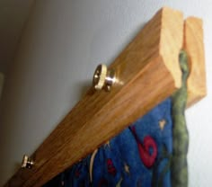 a close up of a wooden curtain rod